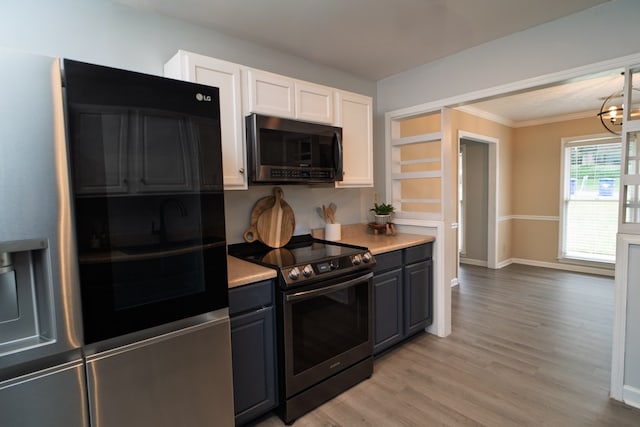 2 Labrador Ct, Columbus, GA 31909 - kitchen with appliances with stainless steel finishes, white cabinetry, light countertops, light wood-type flooring, and ornamental molding
