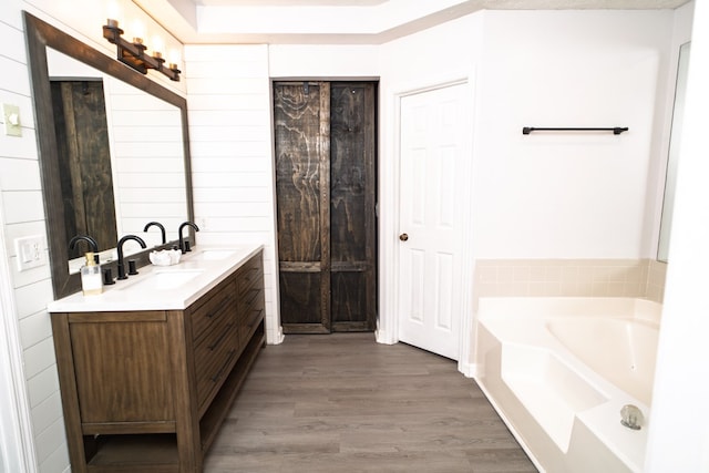 2 Labrador Ct, Columbus, GA 31909 - full bathroom with double vanity, a bath, and wood finished floors