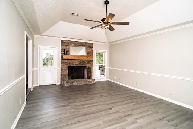 2 Labrador Ct, Columbus, GA 31909 - unfurnished living room with vaulted ceiling, ceiling fan, wood finished floors, a brick fireplace, and a textured ceiling