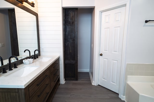 2 Labrador Ct, Columbus, GA 31909 - bathroom with double vanity, wood finished floors, and a bath
