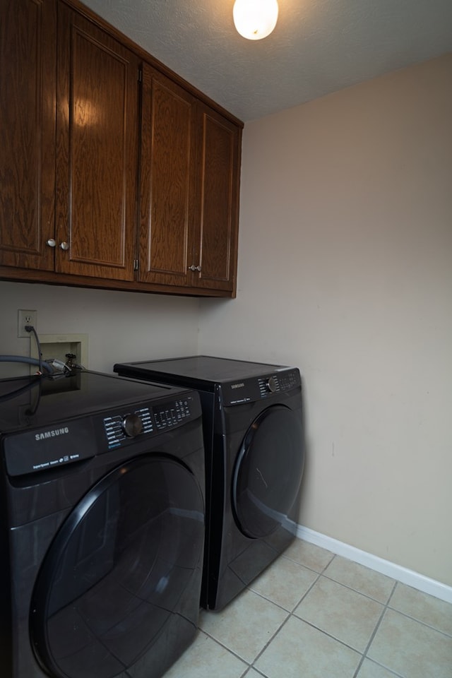 2 Labrador Ct, Columbus, GA 31909 - washroom featuring cabinet space, washing machine and dryer, and light tile patterned floors