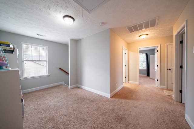 37 Oakwood Dr, Phenix City, AL 36870 - spare room featuring carpet floors, attic access, and a textured ceiling