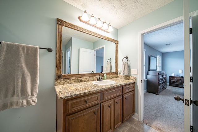 37 Oakwood Dr, Phenix City, AL 36870 - bathroom with vanity and a textured ceiling