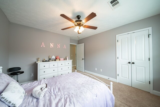 37 Oakwood Dr, Phenix City, AL 36870 - bedroom featuring light carpet, a closet, and a ceiling fan