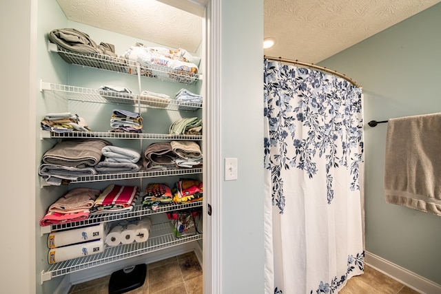 37 Oakwood Dr, Phenix City, AL 36870 - full bathroom with curtained shower, a textured ceiling, and tile patterned flooring