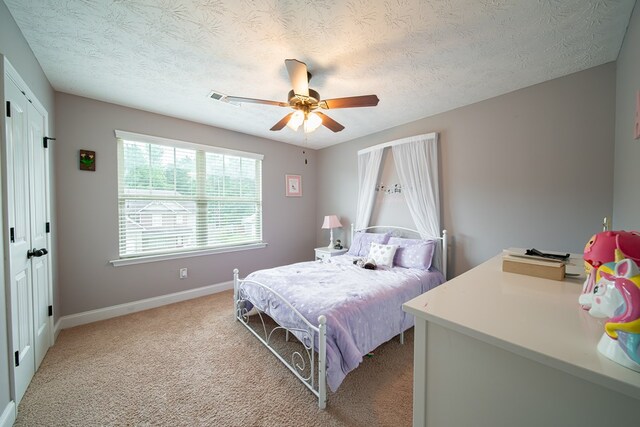 37 Oakwood Dr, Phenix City, AL 36870 - bedroom with a textured ceiling, light carpet, a ceiling fan, and a closet