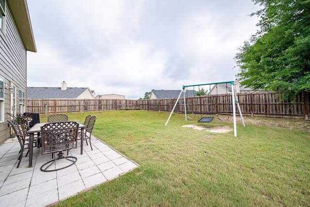 37 Oakwood Dr, Phenix City, AL 36870 - fenced backyard featuring a playground, a patio area, and outdoor dining area