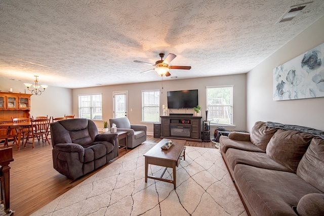 37 Oakwood Dr, Phenix City, AL 36870 - living room featuring light wood-style floors, ceiling fan, a textured ceiling, and a chandelier