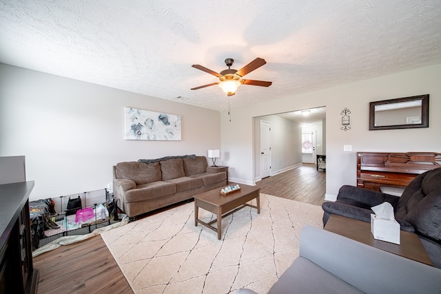 37 Oakwood Dr, Phenix City, AL 36870 - living area with light wood finished floors, a ceiling fan, and a textured ceiling