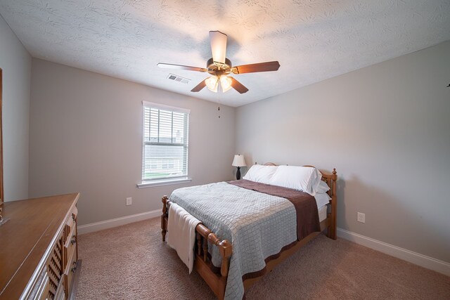 37 Oakwood Dr, Phenix City, AL 36870 - bedroom featuring light carpet, ceiling fan, and a textured ceiling