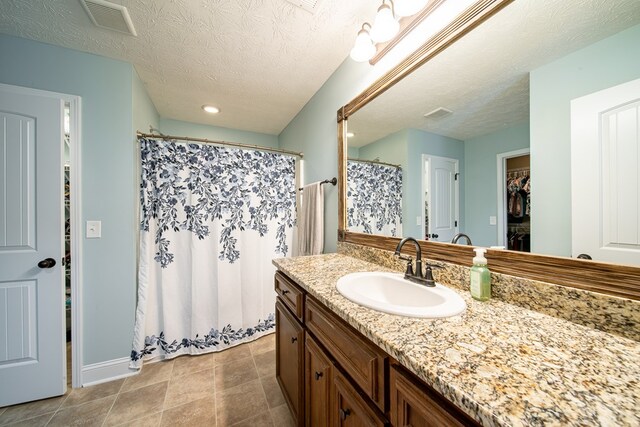 37 Oakwood Dr, Phenix City, AL 36870 - bathroom with vanity, a textured ceiling, curtained shower, and recessed lighting