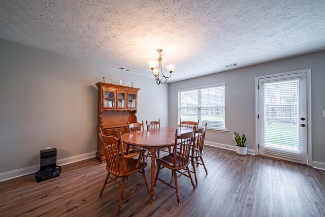 37 Oakwood Dr, Phenix City, AL 36870 - dining space with a chandelier, dark wood-type flooring, a textured ceiling, and plenty of natural light