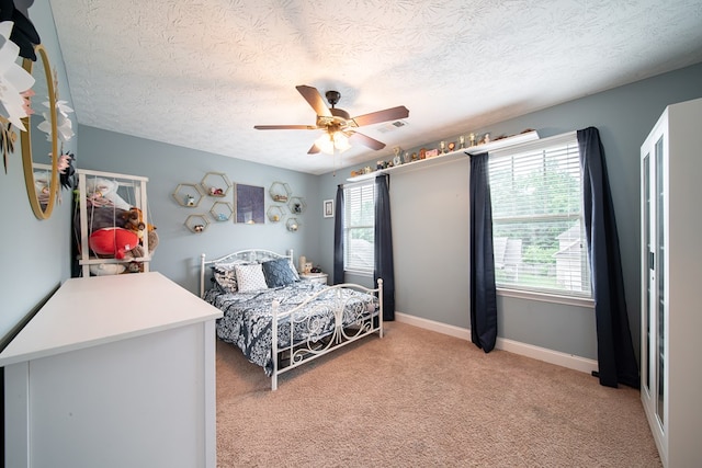 37 Oakwood Dr, Phenix City, AL 36870 - bedroom with multiple windows, a textured ceiling, light colored carpet, and a ceiling fan