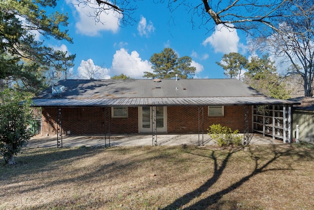 back of property with a patio and a yard