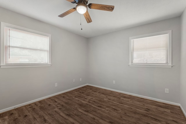 spare room with ceiling fan and dark hardwood / wood-style flooring