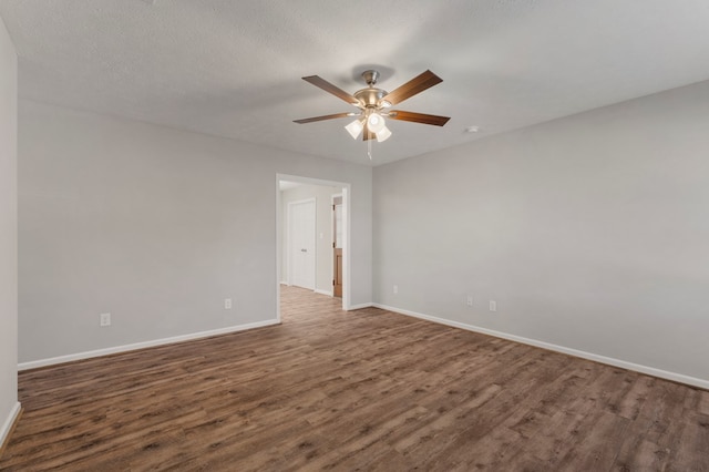 unfurnished room with a textured ceiling, dark wood-type flooring, and ceiling fan