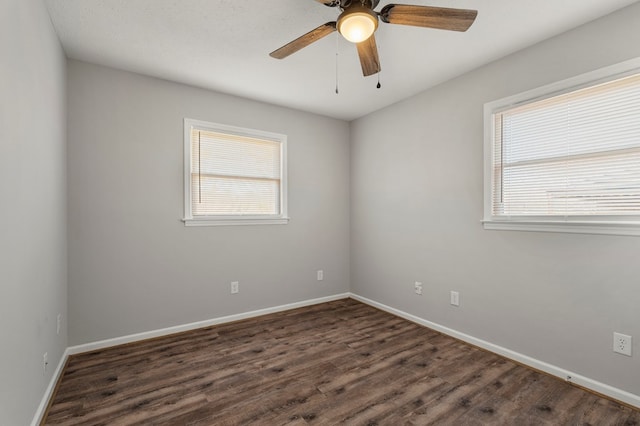 unfurnished room with ceiling fan and dark hardwood / wood-style floors