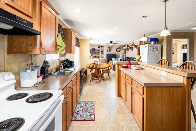 kitchen with ceiling fan, refrigerator, pendant lighting, a kitchen bar, and white electric range oven