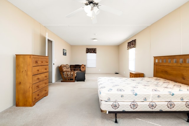 bedroom featuring ceiling fan and light carpet