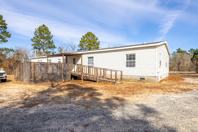 rear view of property featuring a deck