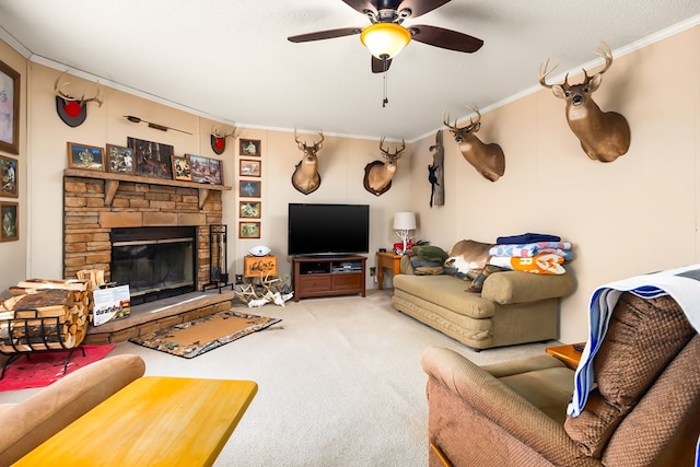 carpeted living room with ceiling fan, a textured ceiling, ornamental molding, and a stone fireplace