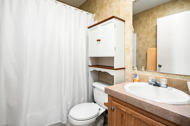 bathroom with toilet and vanity