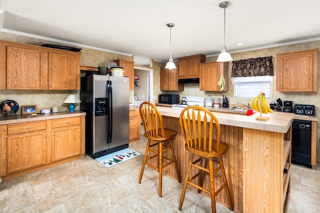 kitchen featuring ornamental molding, a kitchen breakfast bar, black appliances, and a center island