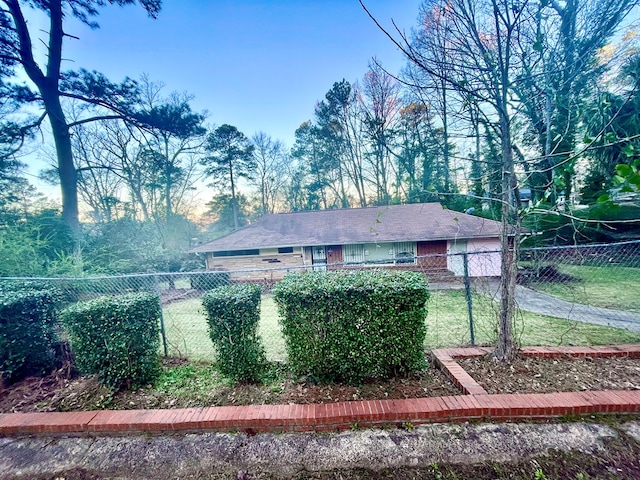 exterior space with brick siding and a fenced front yard