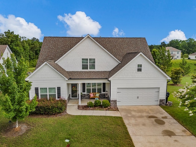 7546 Mockernut Way, Midland, GA 31820 - view of front facade with covered porch, concrete driveway, a front lawn, and roof with shingles