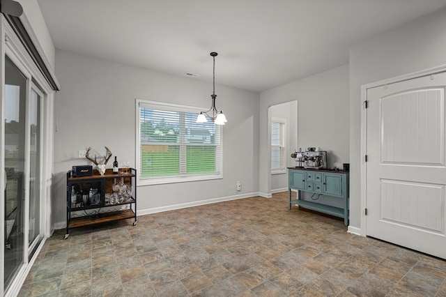 7546 Mockernut Way, Midland, GA 31820 - dining area with stone finish floors, baseboards, and a chandelier