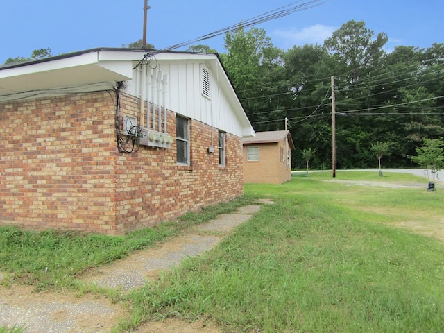 3406 Terminal St, Columbus, GA 31906 - view of home's exterior with brick siding, a yard, and board and batten siding