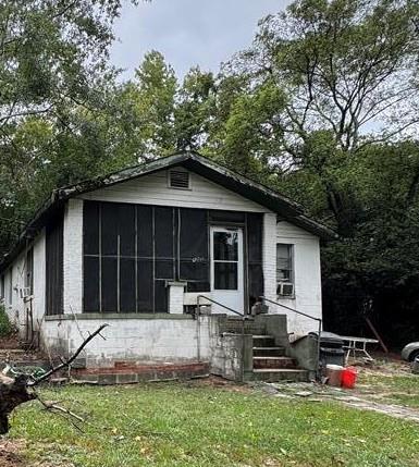 809 15th Ave, Phenix City, AL 36867 - back of property featuring a sunroom and a yard