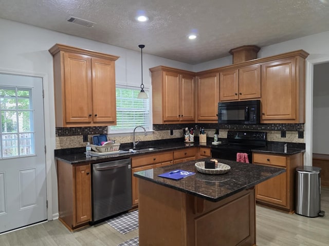 10315 Whisper Glen Ct, Midland, GA 31820 - kitchen featuring black appliances, a sink, light wood-type flooring, plenty of natural light, and a textured ceiling