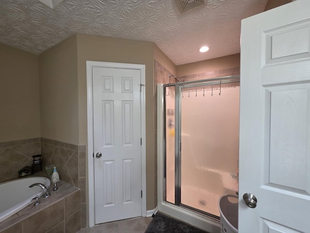 10315 Whisper Glen Ct, Midland, GA 31820 - bathroom featuring a stall shower, a bath, recessed lighting, and tile patterned flooring