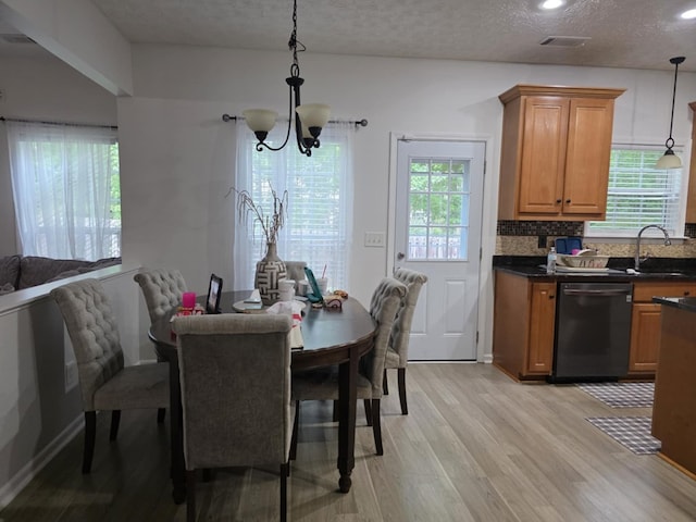 10315 Whisper Glen Ct, Midland, GA 31820 - dining area with light wood-type flooring, a chandelier, a textured ceiling, and recessed lighting