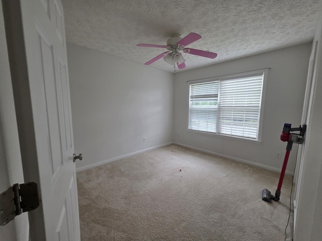 10315 Whisper Glen Ct, Midland, GA 31820 - spare room featuring light colored carpet, a ceiling fan, baseboards, and a textured ceiling