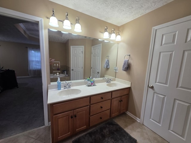 10315 Whisper Glen Ct, Midland, GA 31820 - full bath with double vanity, tile patterned floors, a bathtub, baseboards, and a textured ceiling