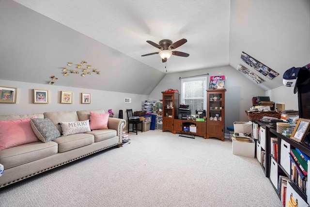 carpeted living room with ceiling fan, vaulted ceiling, and visible vents