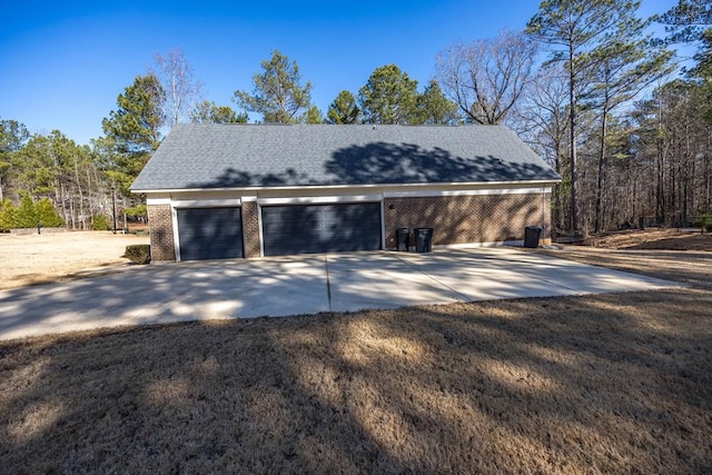 garage featuring concrete driveway