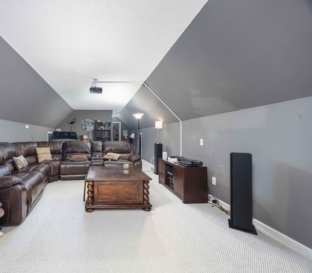 carpeted living area with baseboards and lofted ceiling