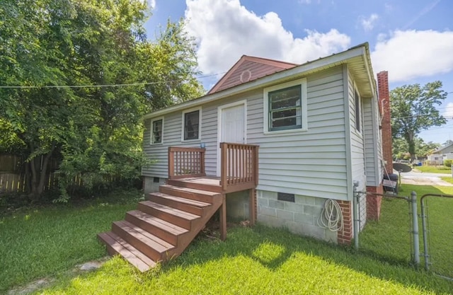 rear view of property with a lawn