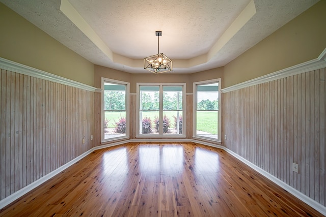 177 Wright Rd, Pine Mountain, GA 31822 - unfurnished room with hardwood / wood-style flooring, a chandelier, a tray ceiling, a textured ceiling, and wooden walls