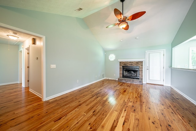 177 Wright Rd, Pine Mountain, GA 31822 - unfurnished living room with vaulted ceiling, attic access, ceiling fan, wood finished floors, and a brick fireplace