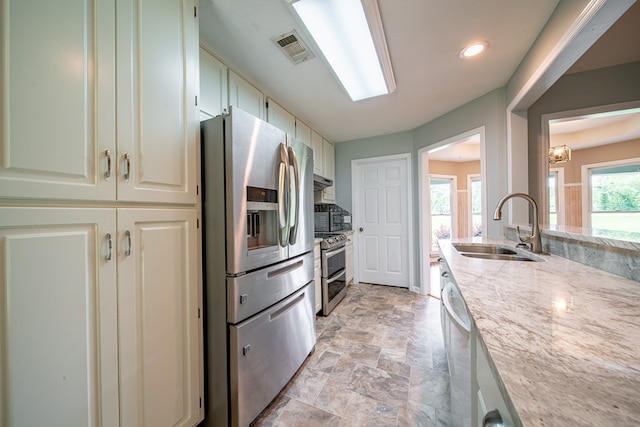 177 Wright Rd, Pine Mountain, GA 31822 - kitchen featuring appliances with stainless steel finishes, light stone countertops, light stone finish floors, decorative backsplash, and recessed lighting