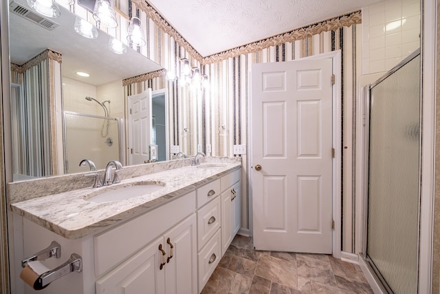 177 Wright Rd, Pine Mountain, GA 31822 - bathroom with a shower stall, double vanity, stone finish floors, and a textured ceiling