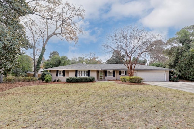 ranch-style home with a front lawn and a garage