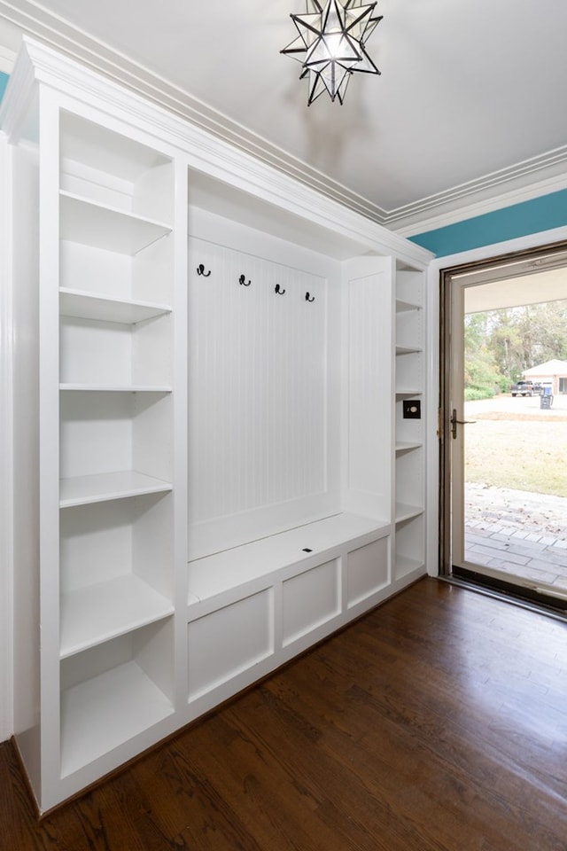 mudroom with dark hardwood / wood-style flooring, ornamental molding, and an inviting chandelier