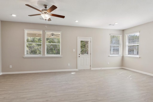 spare room featuring light hardwood / wood-style flooring and ceiling fan