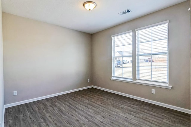 unfurnished room with dark hardwood / wood-style floors