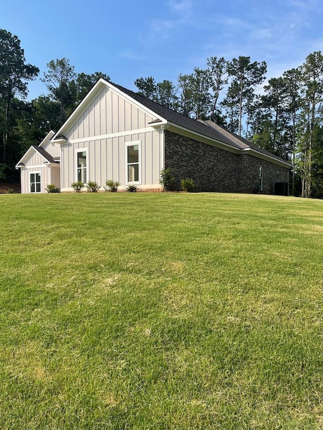 8033 Splendor Way, Columbus, GA 31904 - view of front of property with board and batten siding and a front yard